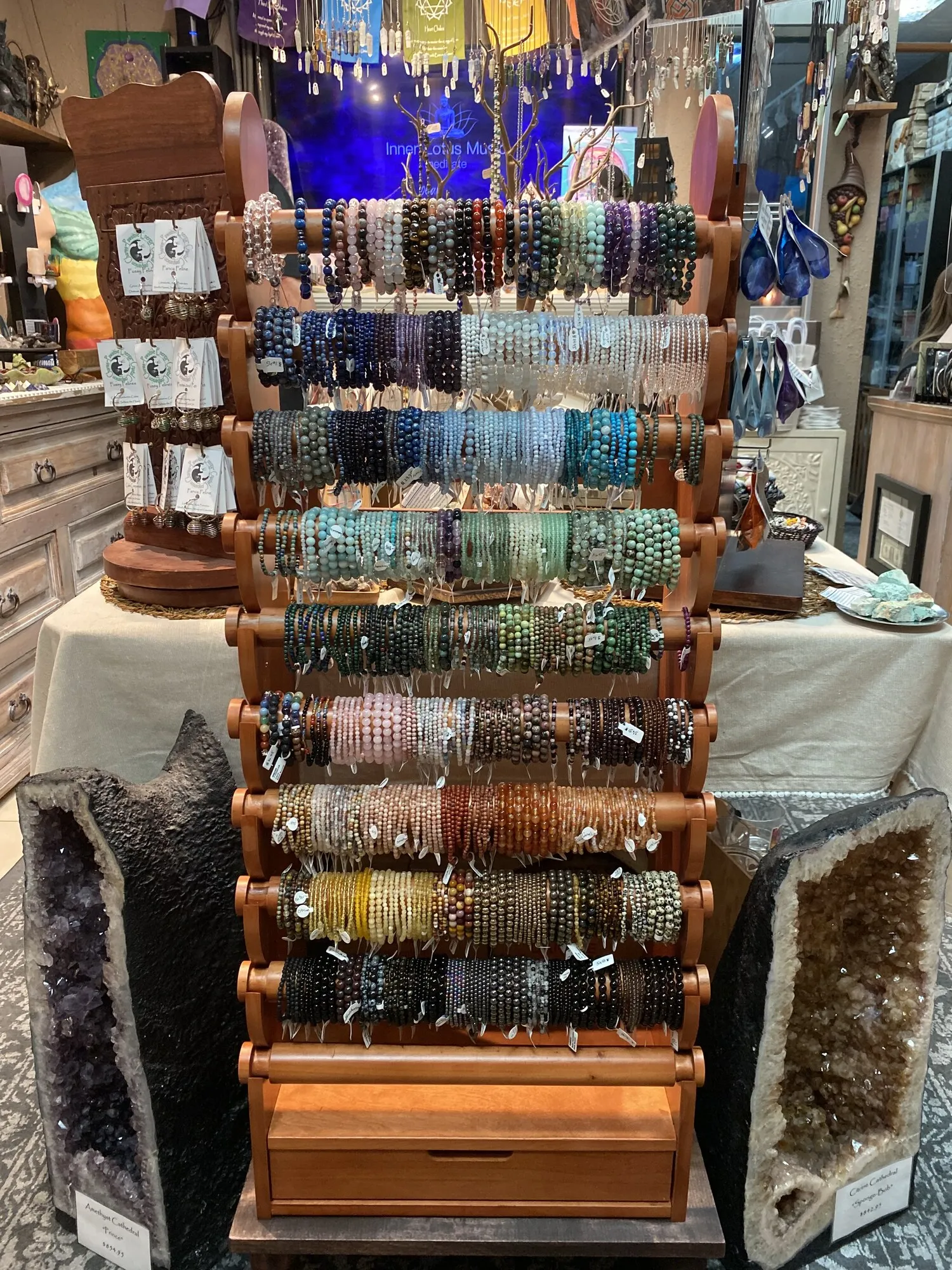 The display used as a retail fixture inside a store, holding beaded bracelets